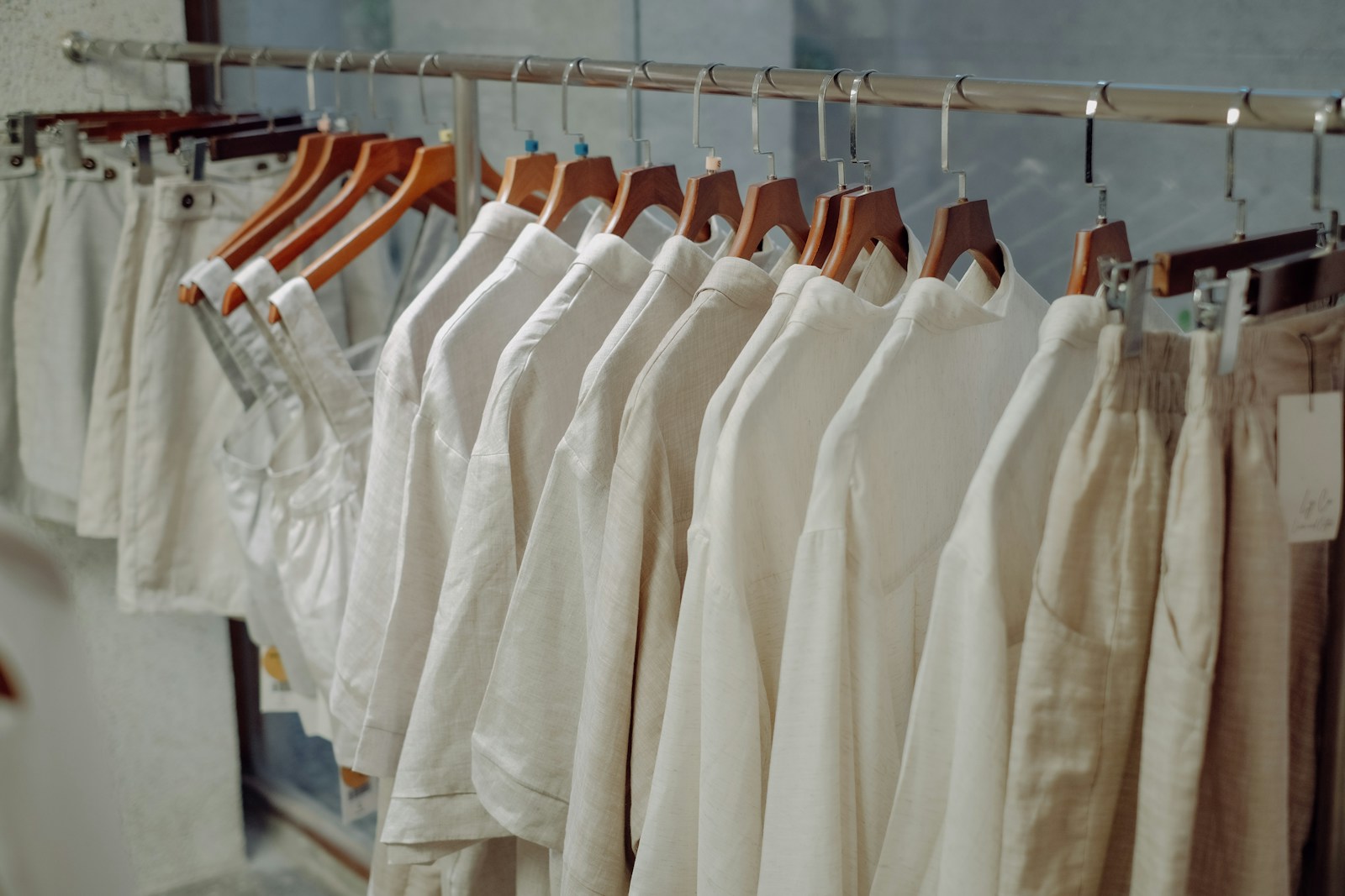 a row of white shirts hanging on a rail